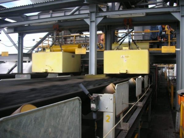 Two yellow machines on the conveyor belt